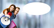 © vgstudio - Expressive happy couple with megaphone mega phone, shop bags. Man and woman shout say advertise use loudspeaker mega phone. Sales ad concept. Blur mall background with white mockup empty speech bubble