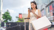 © dodotone - Asian woman city lifestyles using smartphone and shopping with internet banking