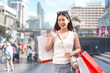 © dodotone - Walking asian woman travel and shopping in city lifestyles at outdoors on day