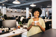 © Jordi Salas - Smiling businesswoman holding coffee mug during office break