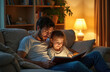 © miss irine - Father and daughter read book on couch at night. Warm lamp light. Cozy living room. Parent reads story, child listens. Family bonding time, learning, imagination.