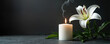© miss irine - White lily flower and burning candle on dark surface. Gentle smoke rises from candle flame. Space for text offers solemn remembrance or condolence message for loss.