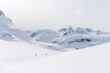 © Michael Hanson - Skiers enjoy a backcountry tour in the Northern Rockies of British Columbia, Canada.