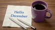 © fatema202 - Hello december message on napkin with coffee cup and pens