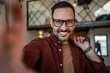 © Migma_Agency - Happy man taking selfie and vlogging lifestyle