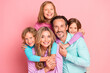© deagreez - Joyful family portrait of parents and children smiling together against a pink background celebrating love and togetherness