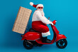 © deagreez - Santa on a bright red scooter delivering holiday cheer with pizza boxes in tow for festive season shopping and Christmas fun