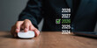 © Mehdi - Hand using a computer mouse to select 2026 on a checklist representing business planning and financial goals for the year