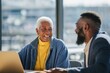 © Shelley - A black female real estate agent with short white hair discusses apartment delivery with her bearded male client in a bright, friendly office setting. Both wear professional attire and smile warmly.