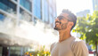© zoro - Happy man smiling outdoors with sunlight and vapor elements in urban setting