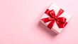 © Bintang - Pastel pink gift box with red ribbon on a plain background