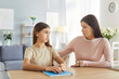 © Studio Romantic - Loving and caring mother assisting teenage daughter with homework and engaging in a supportive conversation at home. Family support and help, education, and the importance of learning.