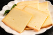 © Alesia Berlezova - Raclette cheese portion slicing natural product tasty snack fresh delicious gourmet food background on the table rustic top view copy space