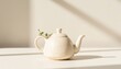 © Анастасия Гува - Elegant ceramic teapot on a table with greenery accent