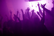 © deagreez - Crowd of friends at a vibrant nightclub event dancing under neon purple lights capturing a festive party atmosphere with music energy