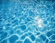© John - bright blue pool water with rippling sunlit surface reflections