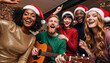 © Milan - Diverse group of friends singing and playing guitar at a Christmas party. Happy young people in Santa hats celebrating the holidays together at home