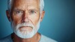 © smartcat - Close-up portrait of a serious elderly man with white hair and beard against a soft blue background showing detailed facial features and thoughtful expression