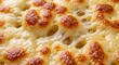 © Ares - Closeup of golden bubbly baked melted cheese texture.