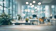 © morepiixel - A blurred office interior with a wooden table in the foreground, illuminated by soft lights, creating a calm and modern workspace atmosphere.