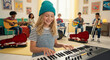 © DH - Smiling girl plays keyboard leading a diverse children's band rehearsal