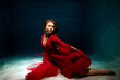 © Cavan Images - Dance in a flowing red dress captured underwater at midday