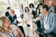 © deagreez - Diverse workplace team engaged in an interactive business meeting together at a modern office setting, promoting teamwork.