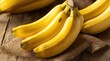 © Kettiketti - Fresh bananas on rustic wooden surface