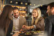 © Creative Light - Friends enjoying a meal together at a stylish restaurant