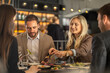 © Creative Light - Friends enjoying a meal together at a restaurant, sharing food and conversation