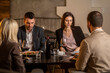 © Creative Light - Friends enjoying a meal together at a restaurant with wine and conversation.