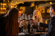 © Creative Light - Friends toasting with red wine at a restaurant, celebrating a special occasion