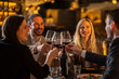 © Creative Light - Friends toasting with red wine at a restaurant, celebrating a special occasion