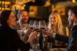 © Creative Light - Friends toasting with wine glasses at a restaurant, celebrating a special occasion