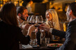 © Creative Light - Friends toasting with red wine at a restaurant, celebrating a special occasion
