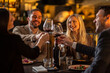 © Creative Light - friends toasting with red wine at a restaurant