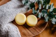 © Виктория Марьенко - Solid shampoo bars resting on wooden board with towel, eucalyptus leaves