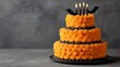 © LuDo - The Halloween cake is orange and decorated with bats, perfect for a spooky party, and is a tasty holiday dessert that is also deliciously sweet