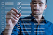 © Pixel Studio - Man completing a digital checklist with a stylus marking off tasks on a virtual todo list for productivity and organization in a modern business or personal management context