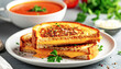 © Bill - Grilled cheese on a white plate and a bowl of tomato soup. AI