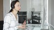© volha_r - Woman consultant interacting on video call, providing online customer support service in modern office. Business people concept