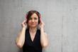 © Halfpoint - A portrait of young businesswoman, listening music.