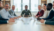 © al-sultan - Diverse professionals gathered around a large table during a meeting, exchanging ideas and collaborating in a modern office environment that emphasizes teamwork, focus, and innovation.
