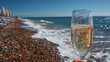 © john - Prosecco in a hand on a beach