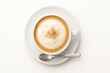© Artcuboy - Top down flat lay of a foamy cappuccino in a white cup centered on a clean saucer with a plain spoon aligned at three oclock