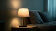 © Plaifah - Cozy bedside lamp casting warm glow in serene bedroom with soft pillows and gentle lighting for a tranquil atmosphere and restful ambiance