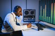 © Serhii - African american police officer records a telephone conversation on a tape recorder. secret agent