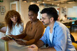 © alvaro - Diverse business team collaborating on tablet in office