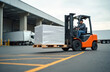 © Vadym - Warehouse worker drives bright orange forklift carrying large white wrapped freight. Man transports goods on wooden pallet near commercial loading dock. Truck waits to load cargo. Essential scene