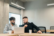 © dsheremeta - Diverse business professionals collaborating on laptop in office